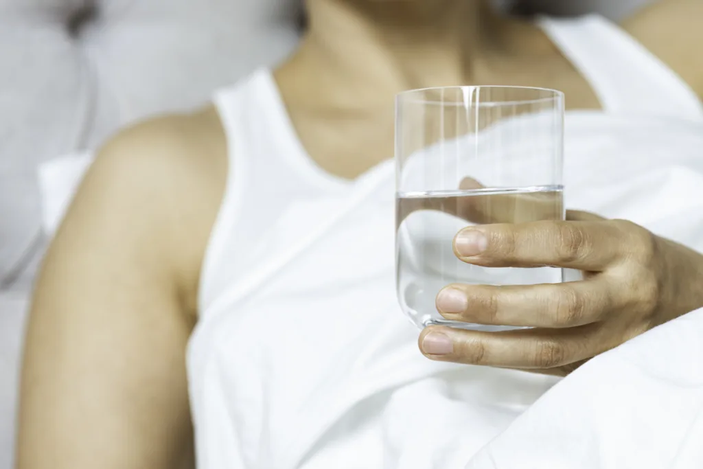 Woman drinking water in morning